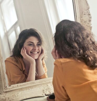 Woman looking at the mirror