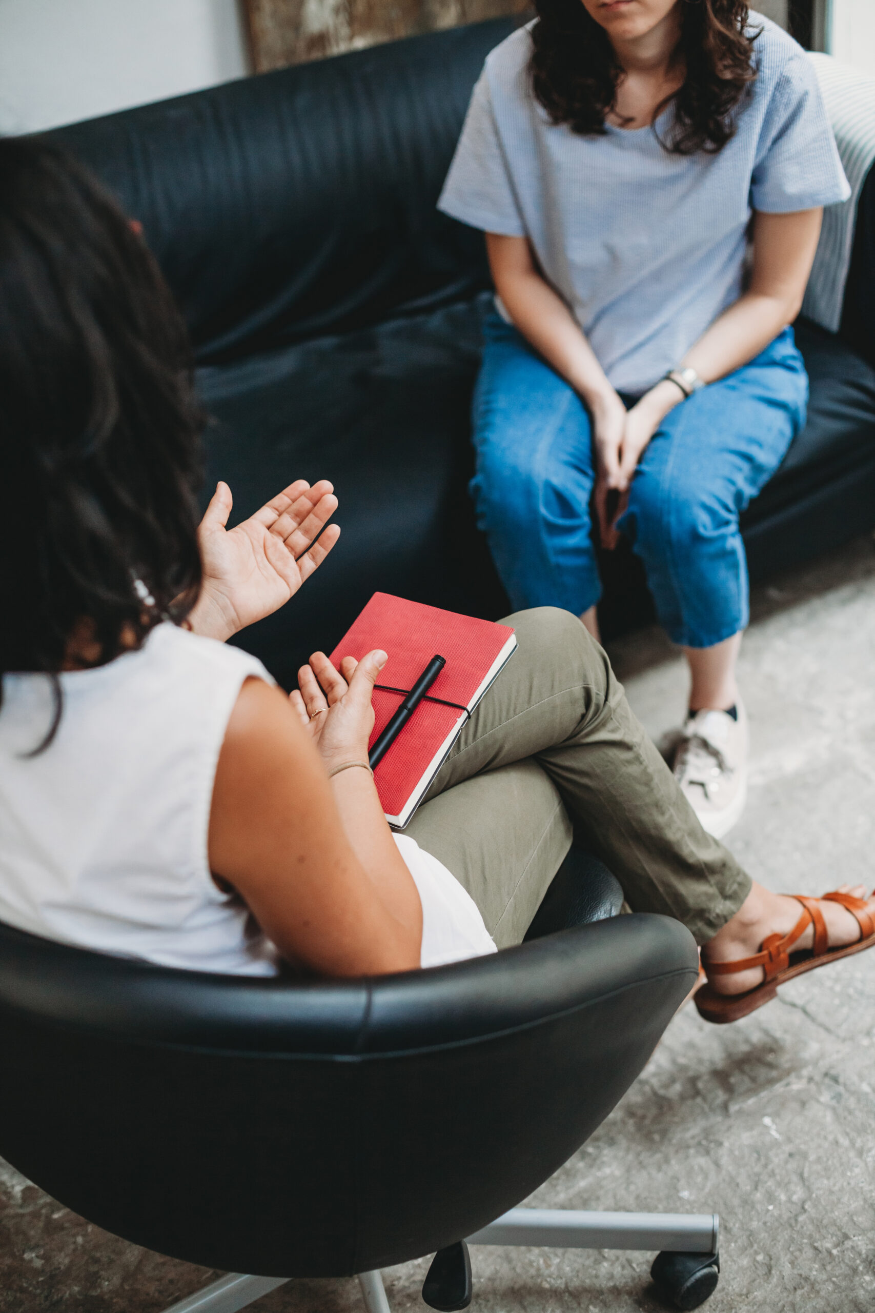 Psychotherapy session, woman talking to his psychologist in the studio