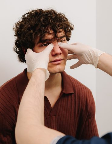 doctor examining patient's nose